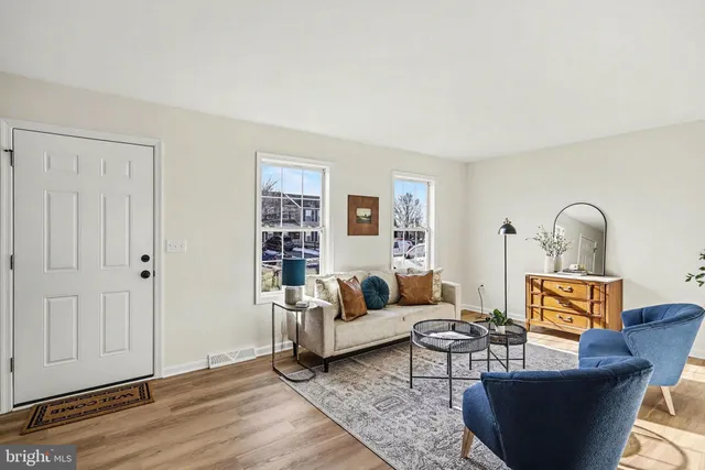 a living room with furniture a rug and a window