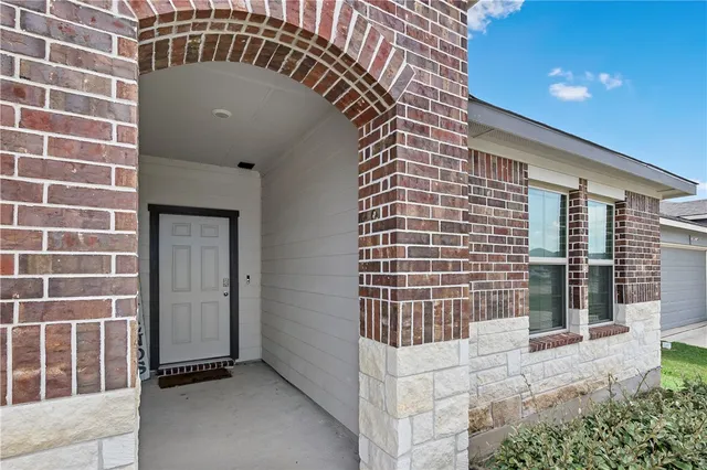 a front view of a house with a glass door