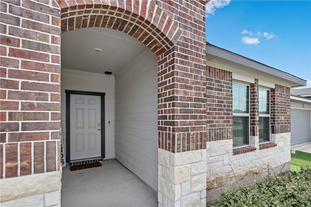 2413 Mulligan Lane Navasota, TX 77868 - Photo 3 of 6 a front view of a house with a glass door