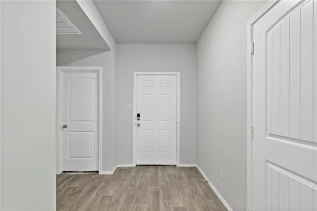 a view of hallway with wooden floor
