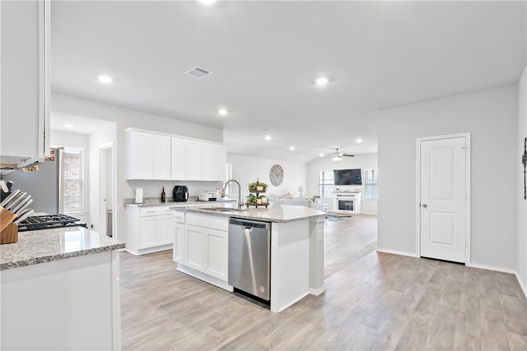 2413 Mulligan Lane Navasota, TX 77868 - Photo 6 of 6 a kitchen with kitchen island a white counter top space a stove and cabinets