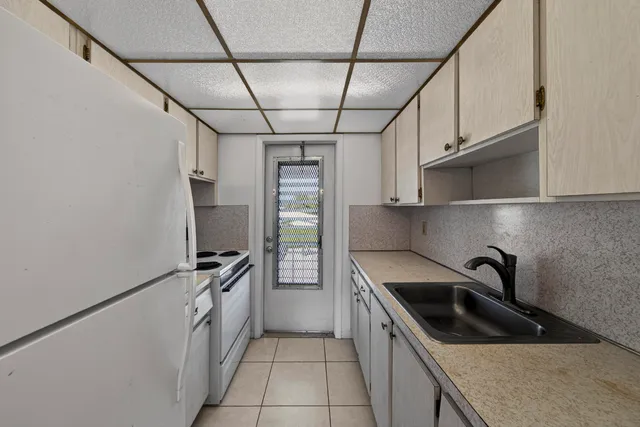 a kitchen with stainless steel appliances a sink a stove and a refrigerator