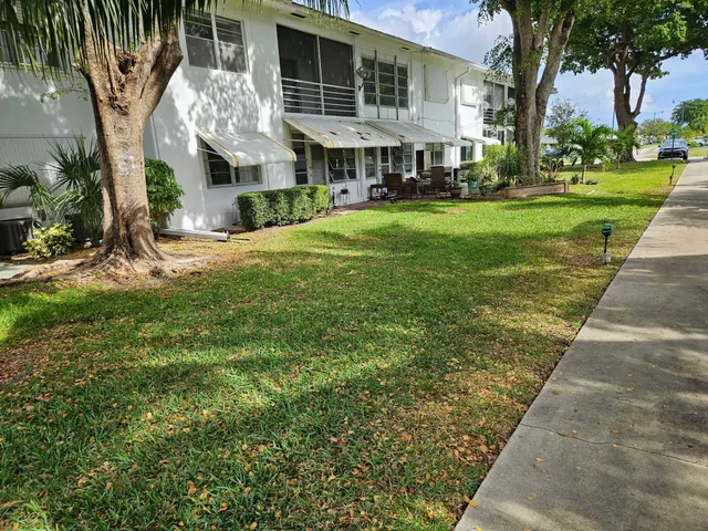 an aerial view of a house with a yard basket ball court and outdoor seating