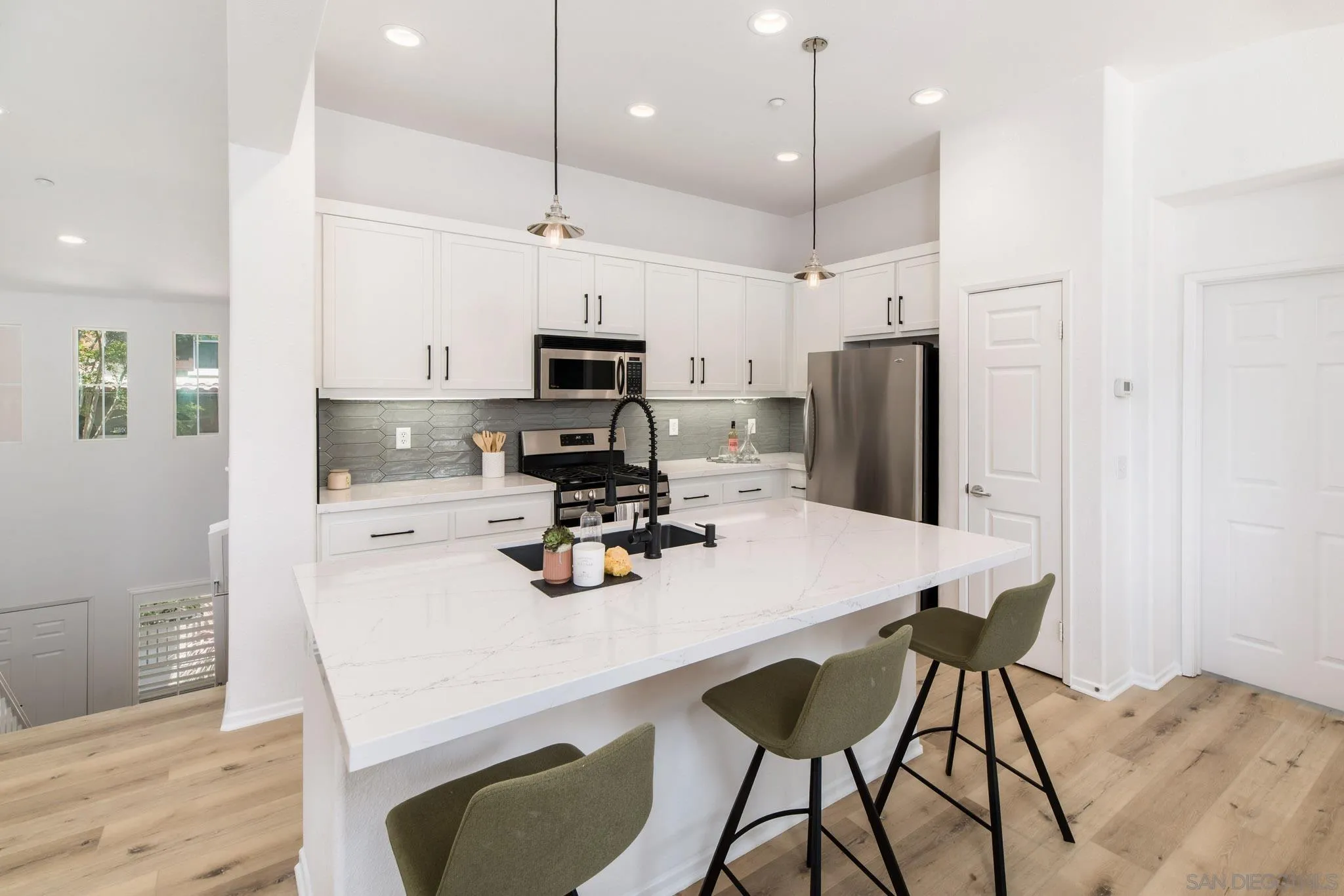 1694 Avery Road San Marcos, CA 92078 - Photo 1 of 22 a kitchen with a dining table chairs refrigerator and microwave