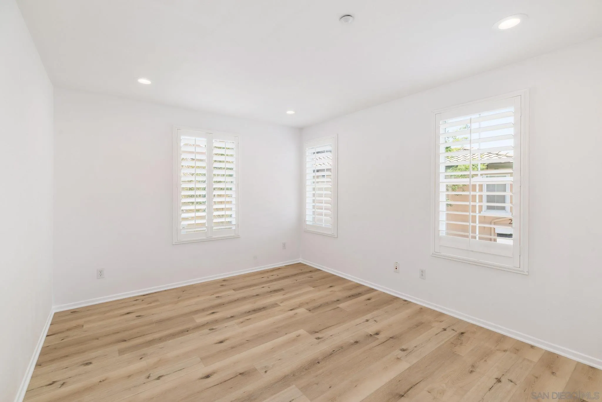 1694 Avery Road San Marcos, CA 92078 - Photo 20 of 22 an empty room with wooden floor and windows