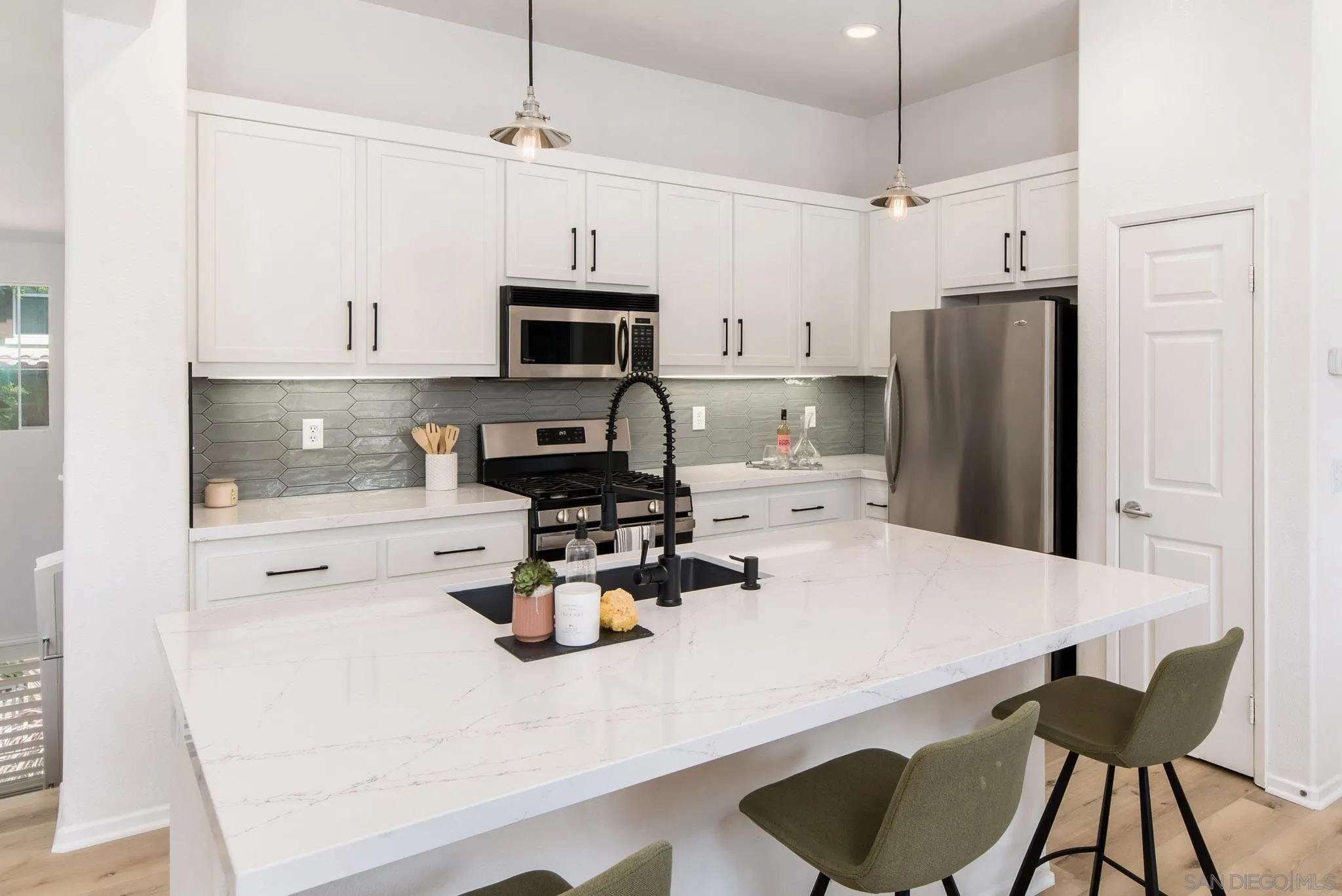 1694 Avery Road San Marcos, CA 92078 - Photo 4 of 22 a kitchen with stainless steel appliances a stove a refrigerator and white cabinets