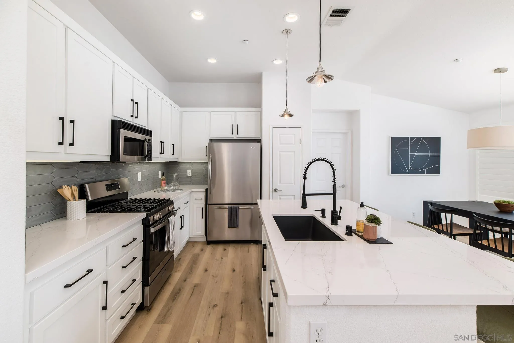 1694 Avery Road San Marcos, CA 92078 - Photo 5 of 22 a kitchen with stainless steel appliances a microwave a sink a stove and a refrigerator