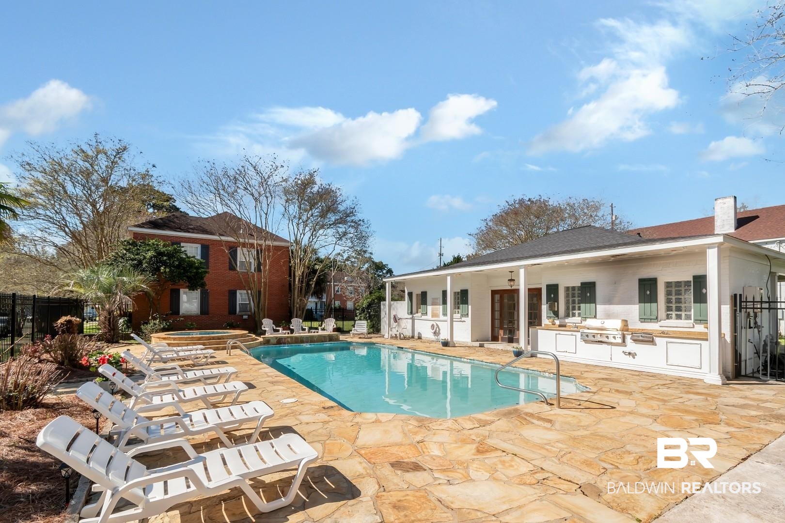 214 Upham Street, Unit 4A Mobile, AL 36607 - Photo 7 of 23 View of pool with a patio, fence, a fenced in pool, exterior kitchen, and an in ground hot tub