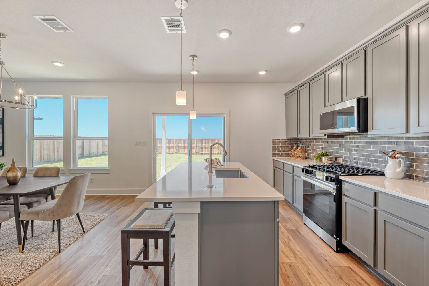 141 Sincere Drive Kyle, TX 78640 - Photo 11 of 23 a large kitchen with kitchen island a large island in the center