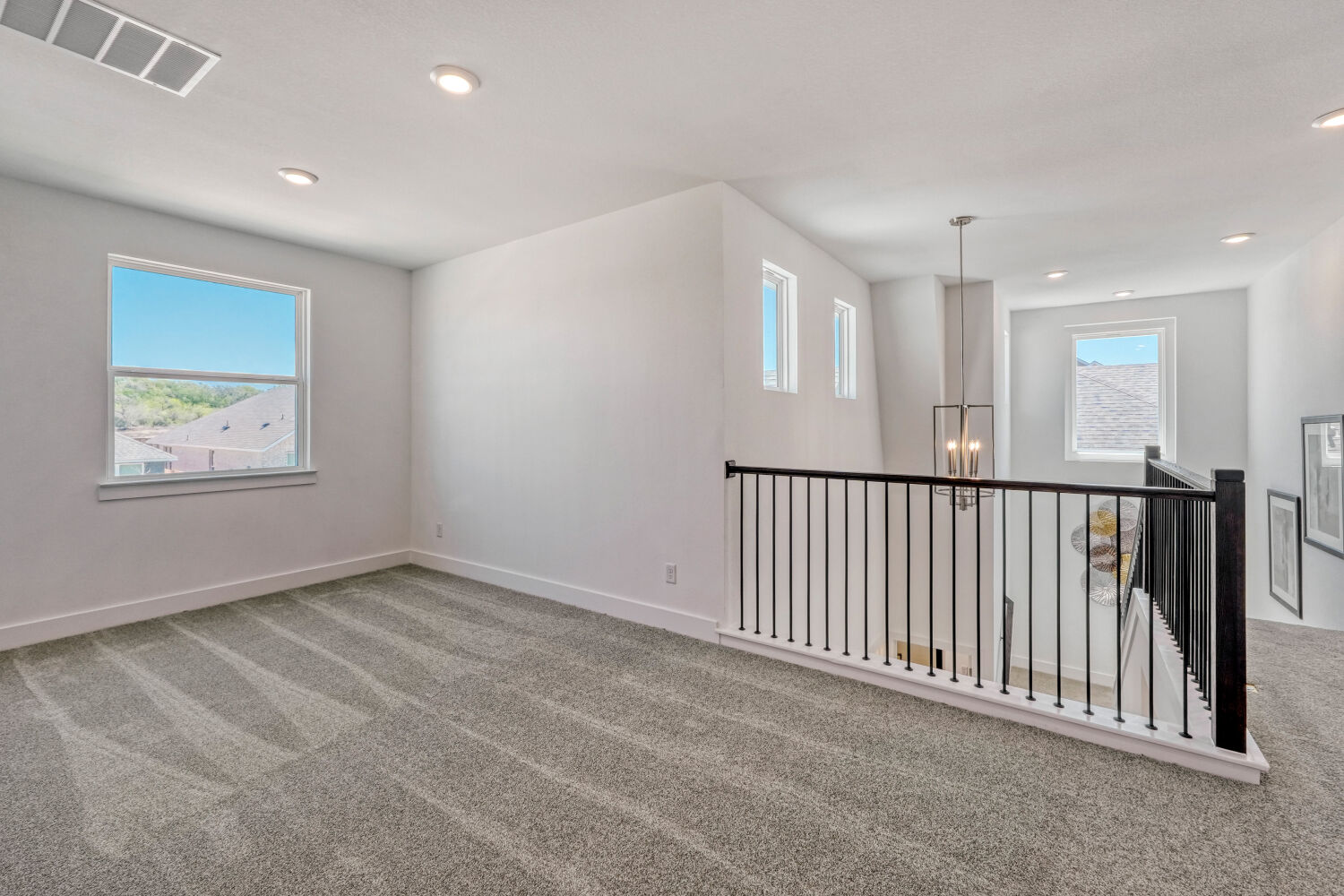 141 Sincere Drive Kyle, TX 78640 - Photo 13 of 23 a view of a hallway with windows