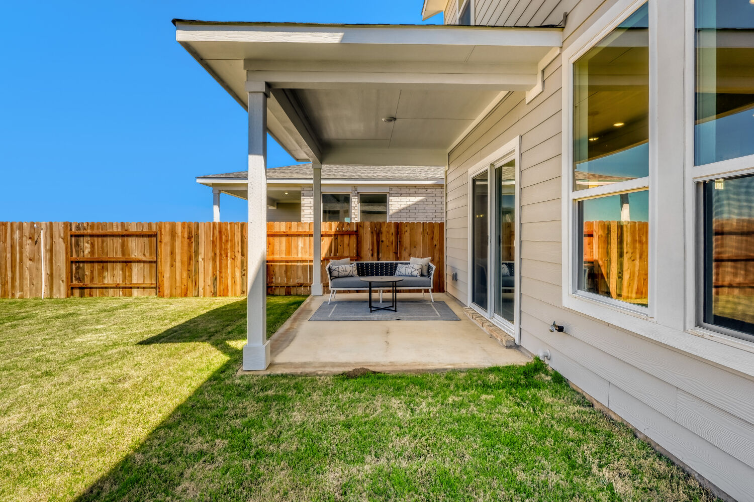141 Sincere Drive Kyle, TX 78640 - Photo 22 of 23 a view of house with backyard porch and furniture