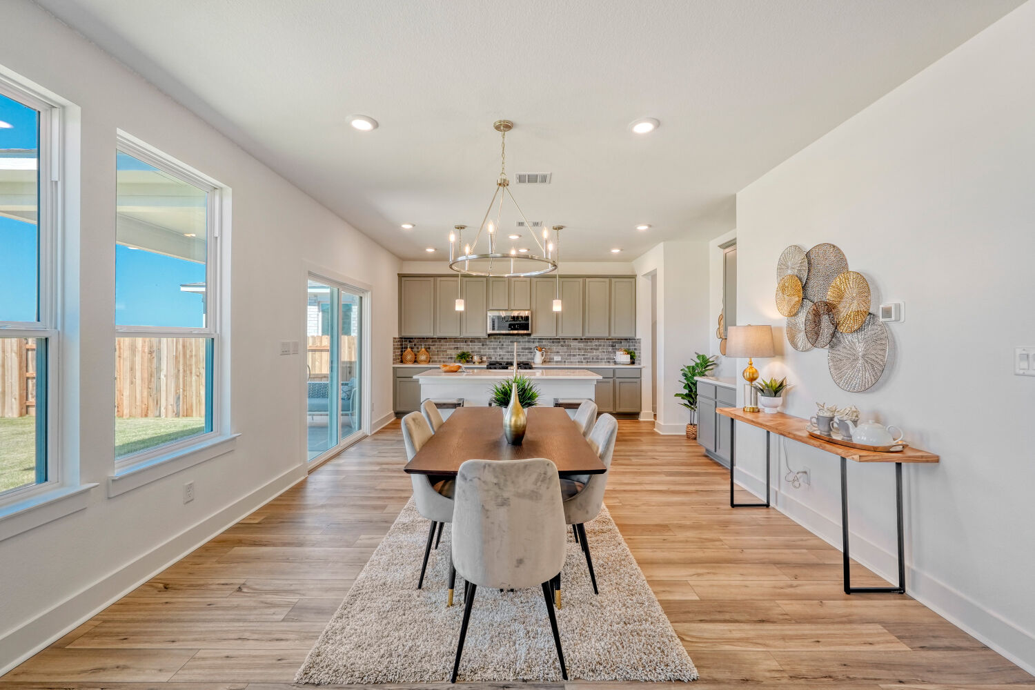 141 Sincere Drive Kyle, TX 78640 - Photo 7 of 23 a view of a dining room with furniture a chandelier and wooden floor