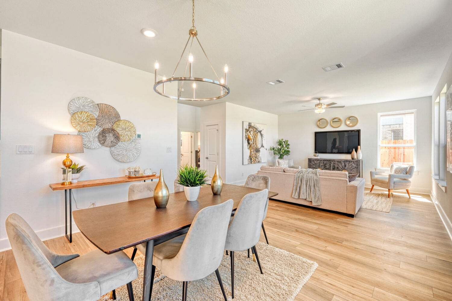 141 Sincere Drive Kyle, TX 78640 - Photo 8 of 23 a view of a dining room with furniture a chandelier and wooden floor