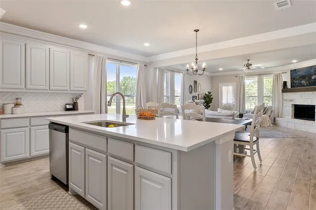 a kitchen with counter top space a sink appliances and cabinets