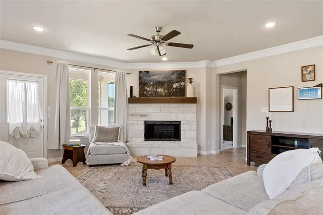 a living room with furniture a flat screen tv and a fireplace