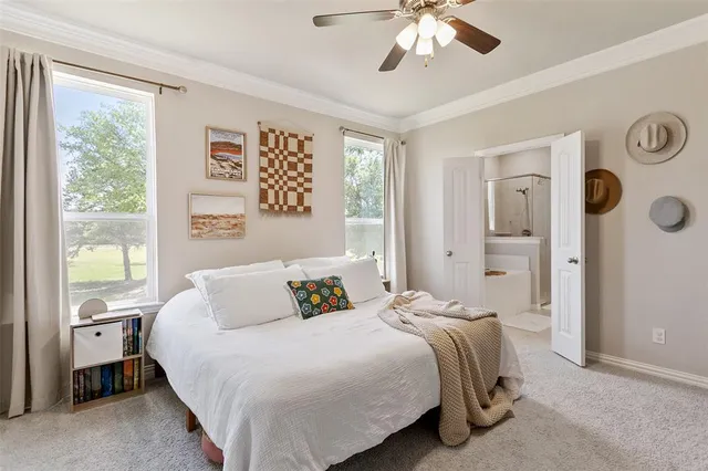 a bedroom with a large bed and a window