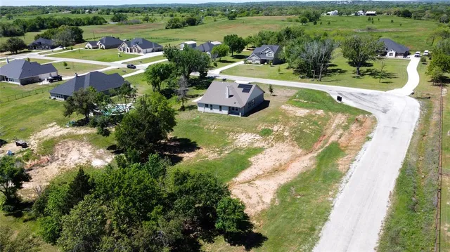 an aerial view of a house with outdoor space swimming pool and mountains