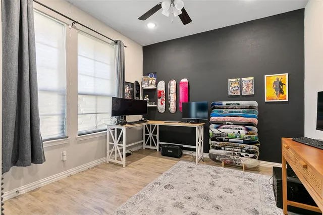 a view of a workspace with furniture and a window