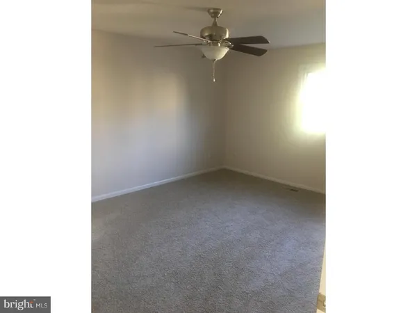 a view of an empty room with a fan
