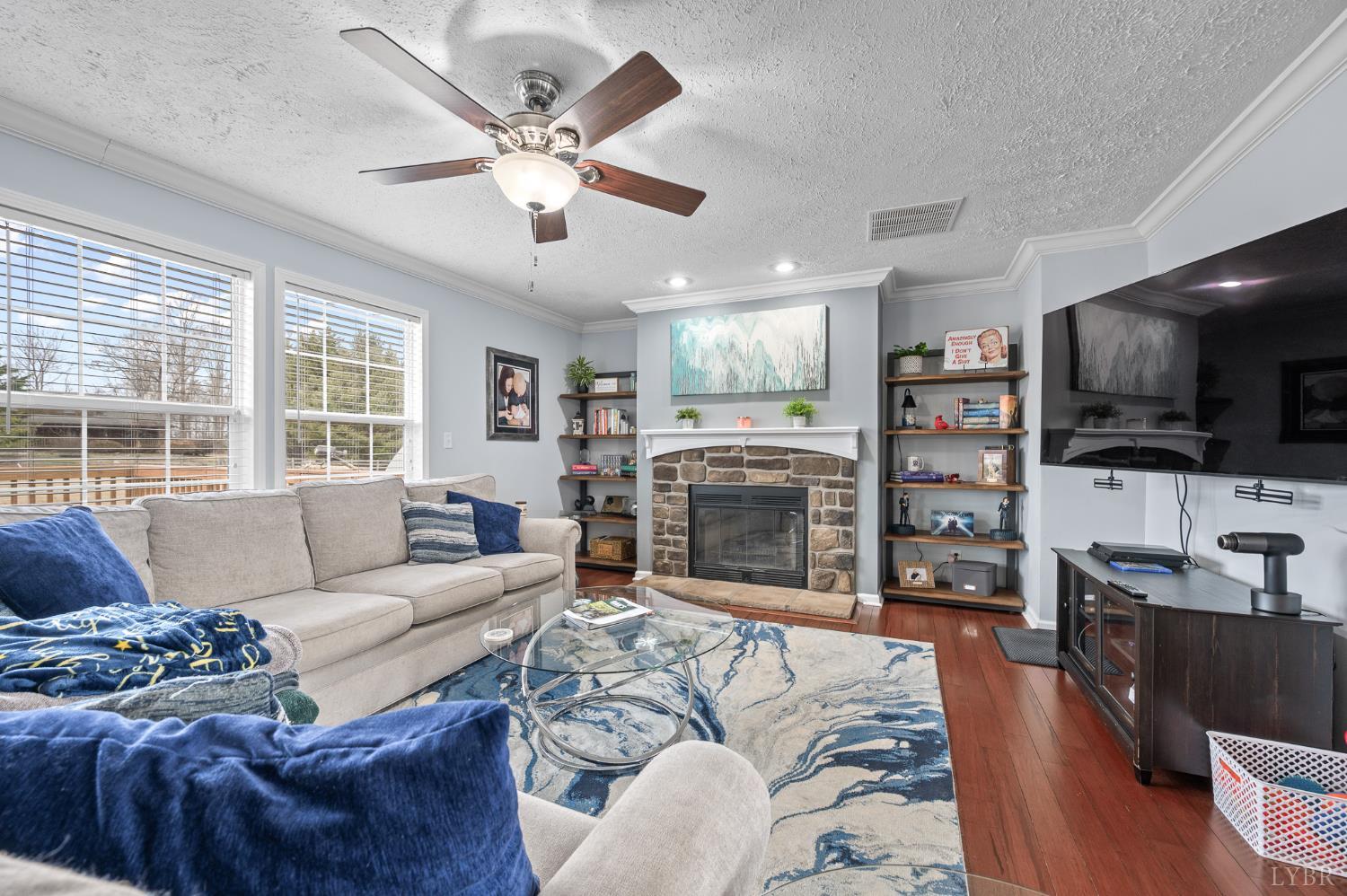 1689 Otter Hill Road Bedford, VA 24523 - Photo 23 of 45 a living room with furniture a fireplace and a flat screen tv