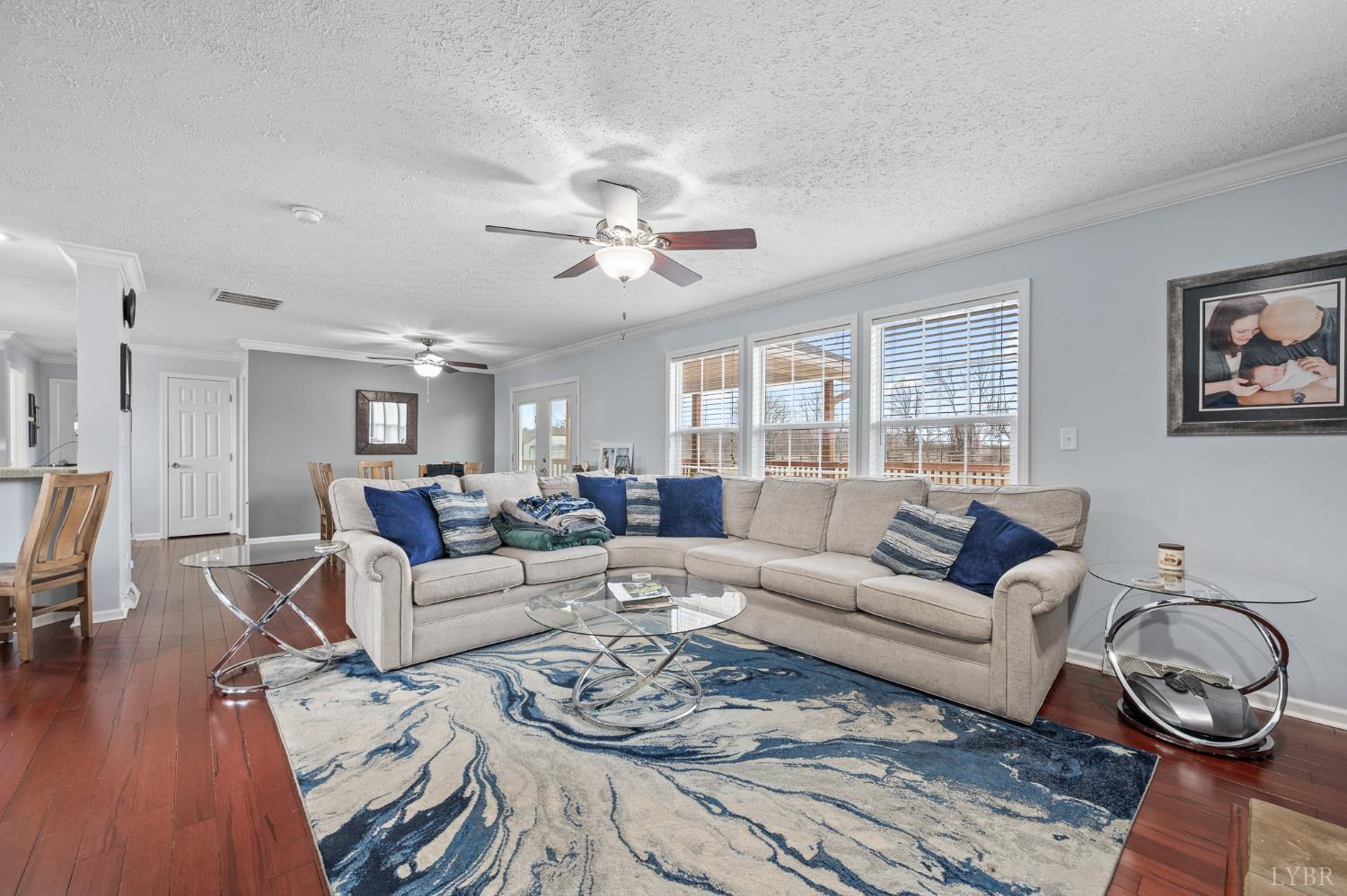 1689 Otter Hill Road Bedford, VA 24523 - Photo 25 of 45 a living room with furniture a wooden floor and a chandelier