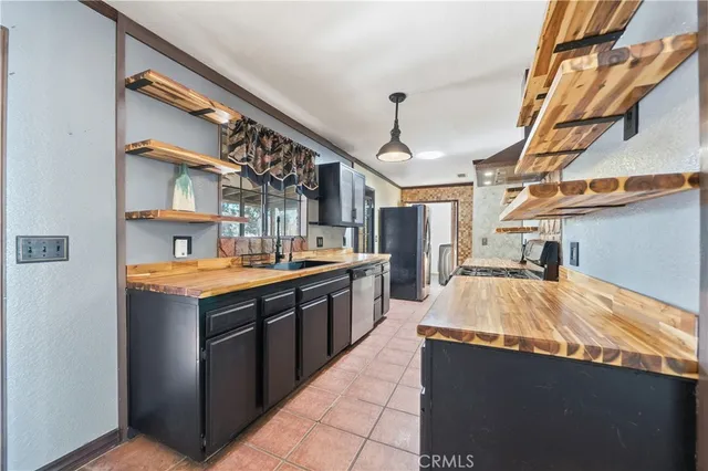 a kitchen with stainless steel appliances granite countertop a sink and wooden cabinets