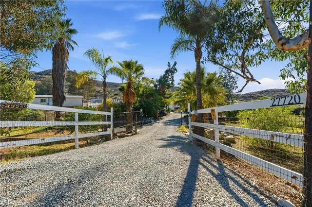 a view of a yard with wooden fence