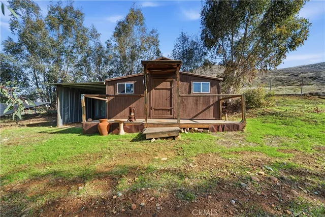 a backyard of a house with barbeque oven fire pit table and chairs