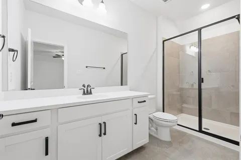 a bathroom with a sink toilet a mirror and shower