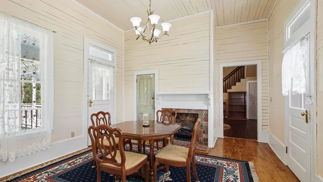 a view of a dining room with furniture and chandelier