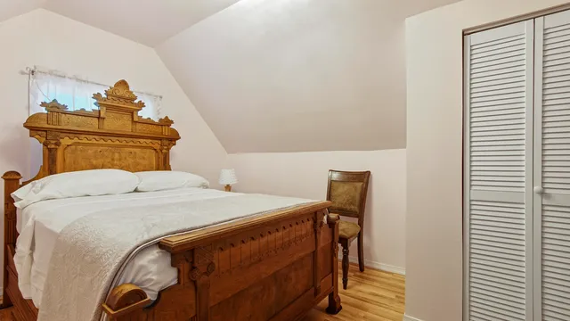 a bedroom with a bed and a dresser