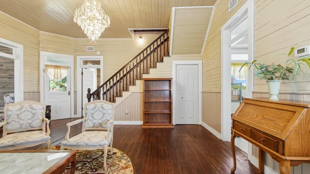 a living room with furniture and a chandelier