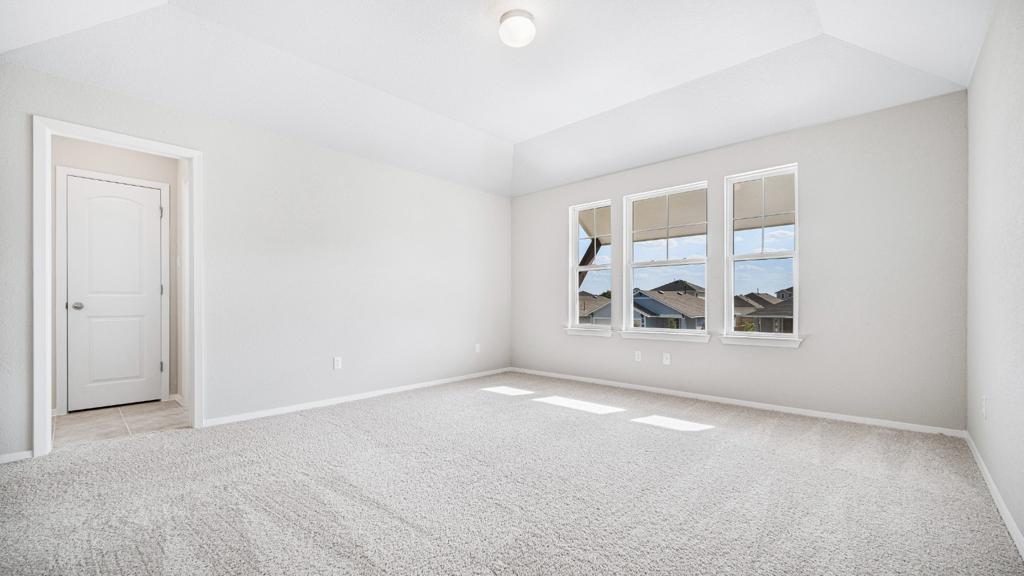 208 Stein Road Georgetown, TX 78626 - Photo 11 of 30 Empty room featuring carpet and lofted ceiling