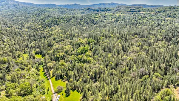 a backyard of a house with barbeque oven