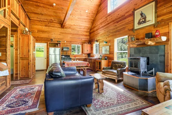 a view of a dining room with furniture a chandelier and wooden floor