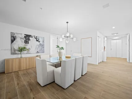 a large white kitchen with wooden floor