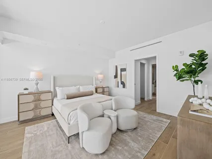 an empty room with wooden floor and windows with sliding door