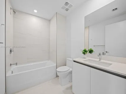 a utility room with sink dryer and washer