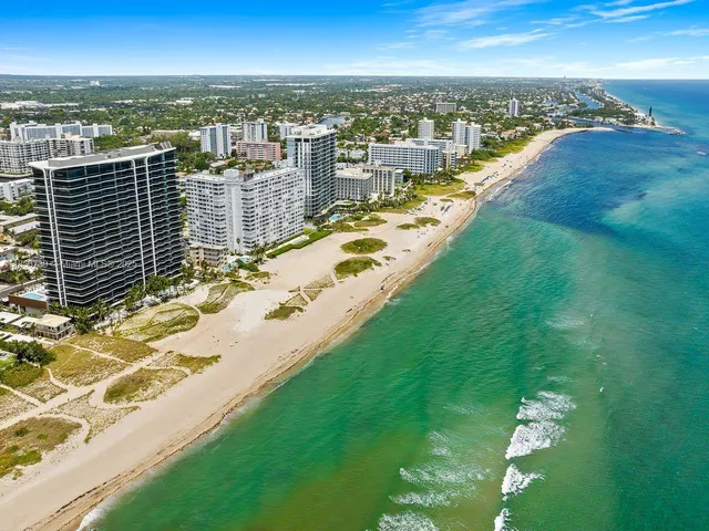 a living room with fireplace furniture and a potted plant