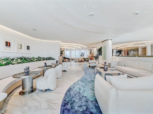 a room with pool table and windows