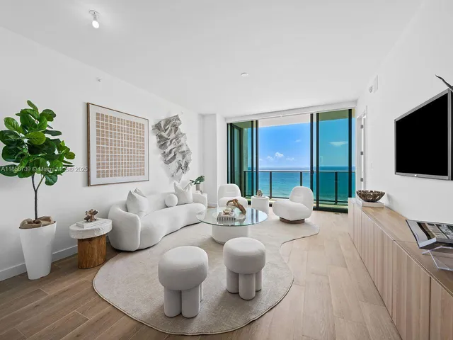 a large kitchen with a large window and stainless steel appliances