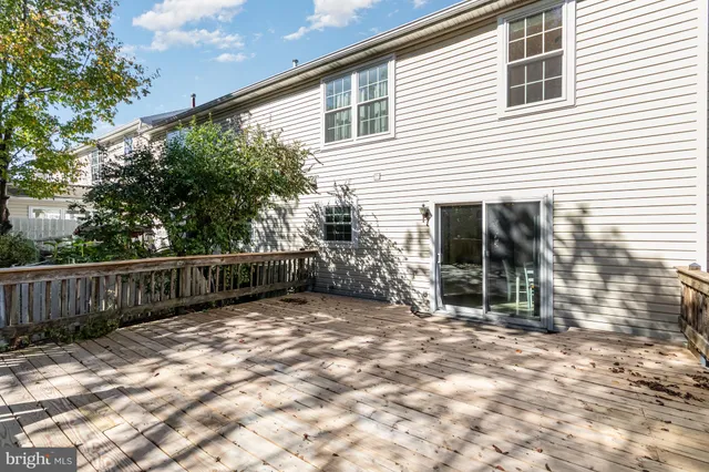 a view of backyard with small cabin and wooden fence