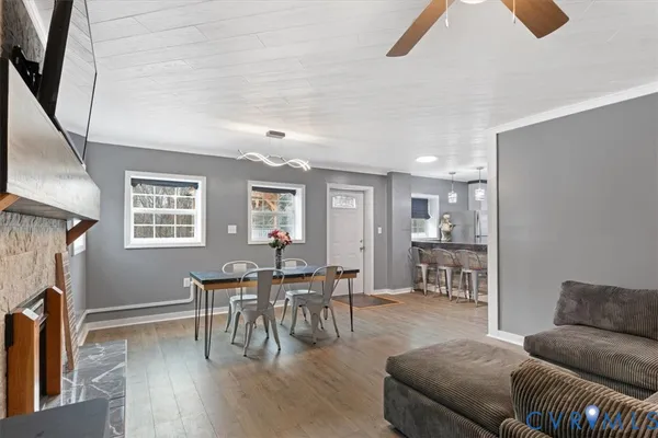 a kitchen with granite countertop white cabinets and a stove