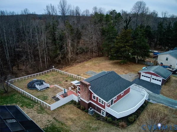 an aerial view of a house with outdoor space
