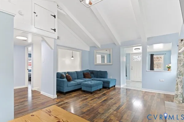 a living room with a fireplace and a flat screen tv