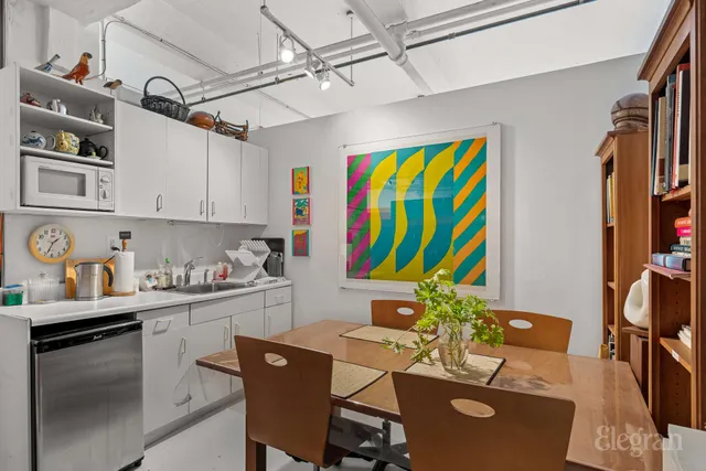 a kitchen with stainless steel appliances granite countertop a sink dishwasher and a refrigerator with wooden floor