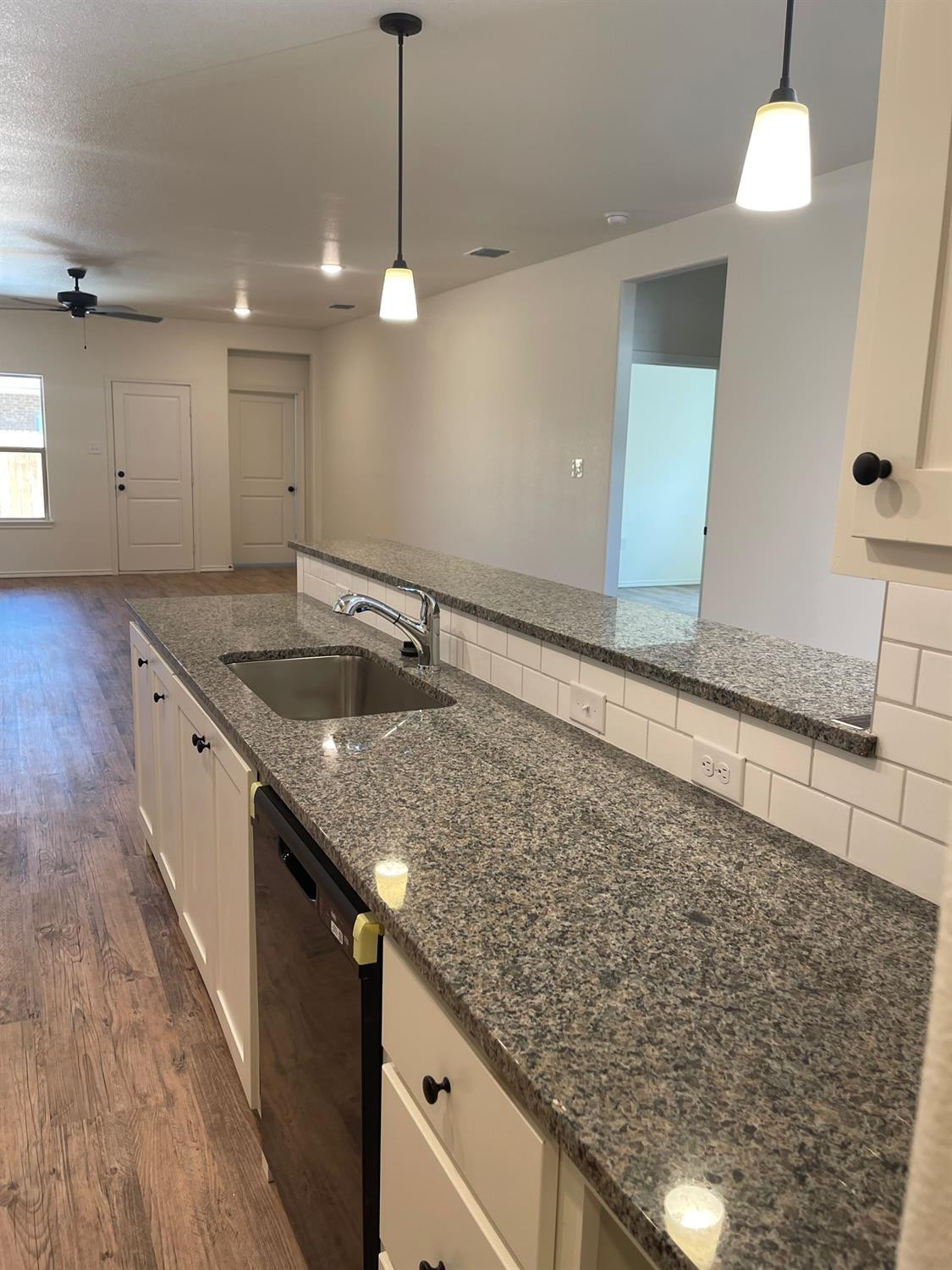 5536 Kemper Street Lubbock, TX 79416 - Photo 7 of 13 a kitchen with a sink and a mirror