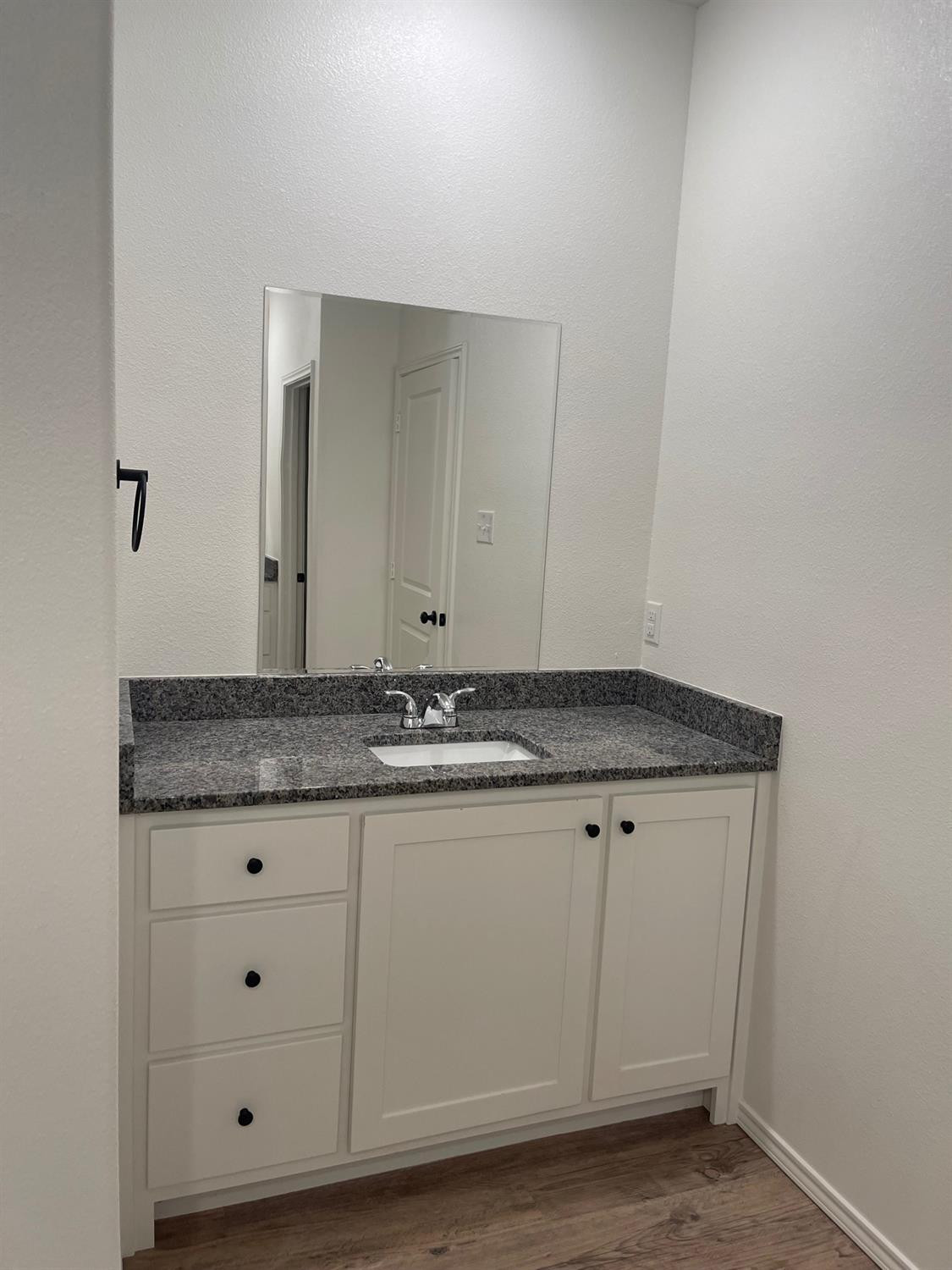 5536 Kemper Street Lubbock, TX 79416 - Photo 9 of 13 a view of a granite countertop white cabinets and a sink