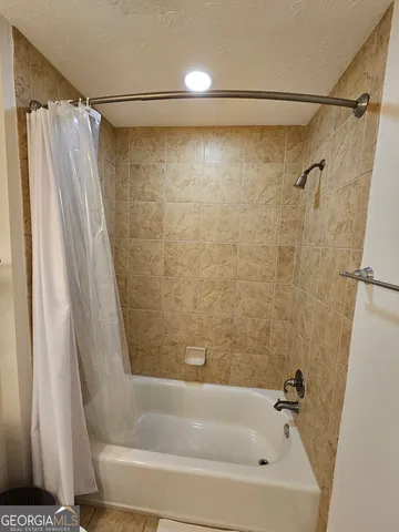 a bathroom with a shower and a tub