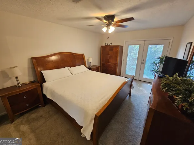 a bed room with a bed and a television